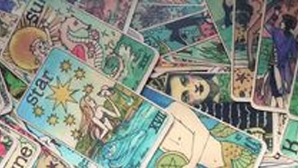 A close up of tarot cards on top of each other