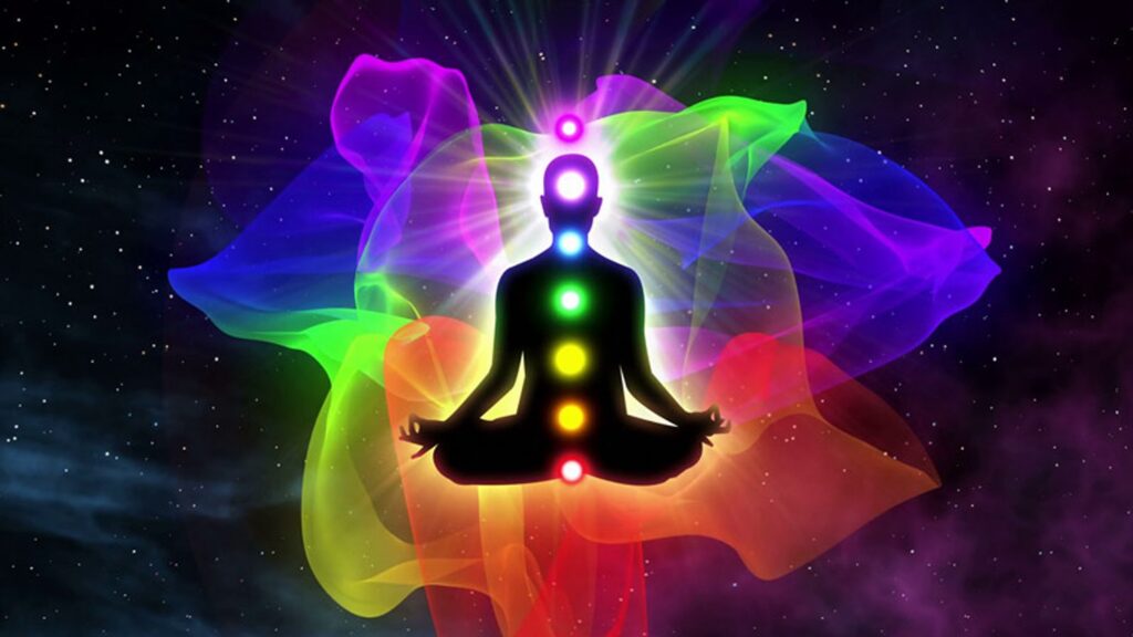 A person sitting in the lotus position with seven chakras on their shoulders.